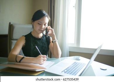 Asian Business Woman Calling In The Office Room.