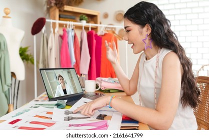 Asian business woman fashion designer talking to her colleagues about plan fashion design in video conference. working from home concept. - Powered by Shutterstock