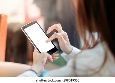 Asian business woman holding and using smart phone with white blank empty screen.