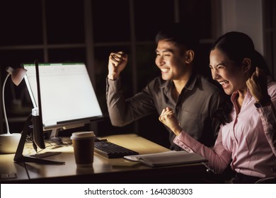 Asian Business Woman And Business Man Working Hard Late Together With Technology Computer In Office,team Work With Colleagues To Congratulations For Success Achievement Project Concept