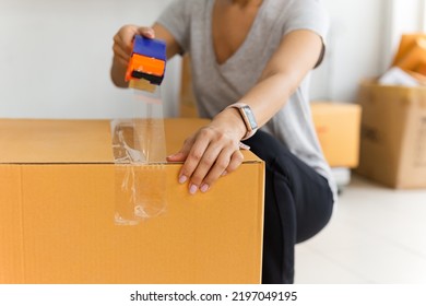 Asian Business Woman Packing Product Sealing Cardboard With Duct Tape