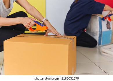 Asian Business Woman Packing Product Sealing Cardboard With Duct Tape