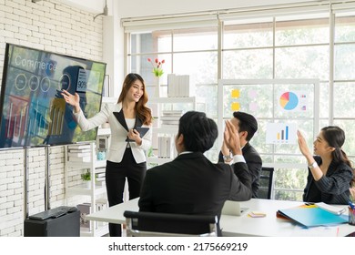 Asian Business Woman Present Business Strategy Plan To Corporate Colleagues In The Meeting Room. Group Of Asian Businesspeople Meeting Business Plan On White Board In The Office.