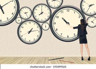 Asian business woman repair the clock, concept of time management, rebuild, busy etc.