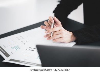 Asian Business Woman Reviewing Data In Financial Charts And Graphs. Accounting Concept