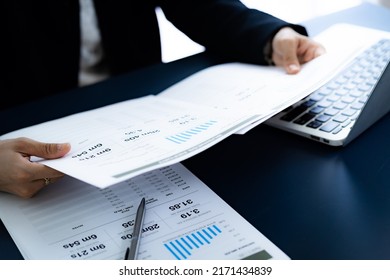 Asian Business Woman Reviewing Data In Financial Charts And Graphs. Accounting Concept