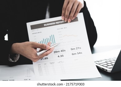 Asian Business Woman Reviewing Data In Financial Charts And Graphs. Accounting Concept