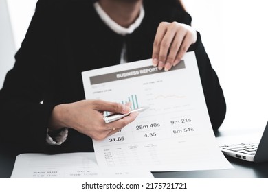 Asian Business Woman Reviewing Data In Financial Charts And Graphs. Accounting Concept