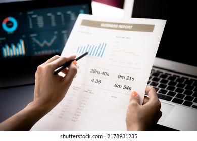 Asian Business Woman Reviewing Data In Financial Charts And Graphs With Tablet. Accounting