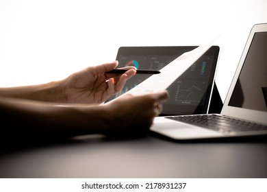 Asian Business Woman Reviewing Data In Financial Charts And Graphs With Tablet. Accounting