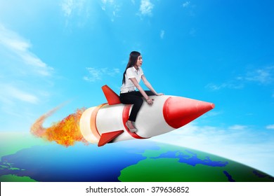 Asian Business Woman Riding Rocket Across The Earth