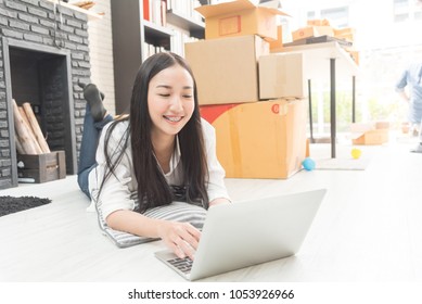 Asian business woman selling online marketing, shipping concept, startup small business working with computer at workplace. seller check product order and inventory, packing for delivery to customer. - Shutterstock ID 1053926966