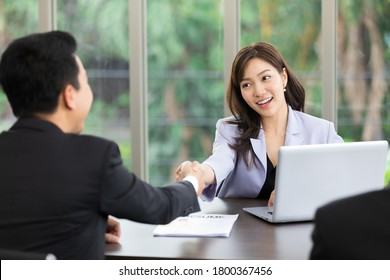 Asian Business Woman Shaking Hands After A Successful Job Interview At Office