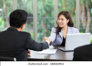 Asian Business Woman Shaking Hands After A Successful Job Interview At Office