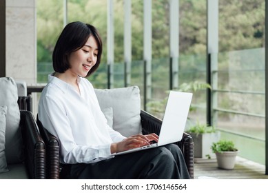 An Asian Business Woman With Short Hair Is Working