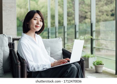 An Asian Business Woman With Short Hair Is Working