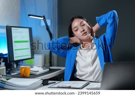 Asian business woman sitting in a chair stretching Relax with relief. Meditate after work from fatigue As she sat and worked for a long time Office Syndrome.
