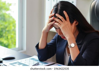 Asian Business Woman Sitting In The Office With Stress, Women Are Not Happy At Work.