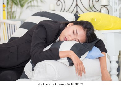Asian Business Woman Sleep on sofa after working day