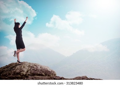 Asian Business Woman Standing On The Top Of The Mountain. Business Success Concept