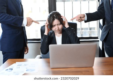 Asian business woman in a suit receiving power harassment in the office - Shutterstock ID 2320702029