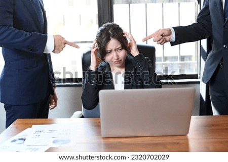 Asian business woman in a suit receiving power harassment in the office