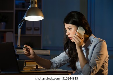 Asian Business Woman Talk On Smartphone Working Overtime Late Night. Indoors Office Background