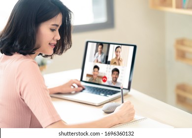 Asian business woman talking to colleague team about plan in video conference. Group of multiethnic business people using computer for online meeting in video call conference. Smart working from home.