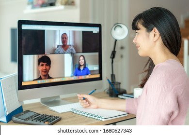 Asian business woman talking to her colleagues about plan in video conference. Multiethnic business team using computer for a online meeting in video call. Group of people smart working from home.
 - Shutterstock ID 1680627343