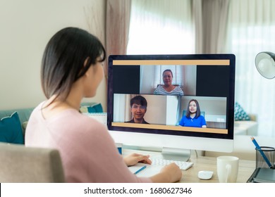 Asian business woman talking to her colleagues about plan in video conference. Multiethnic business team using computer for a online meeting in video call. Group of people smart working from home.
