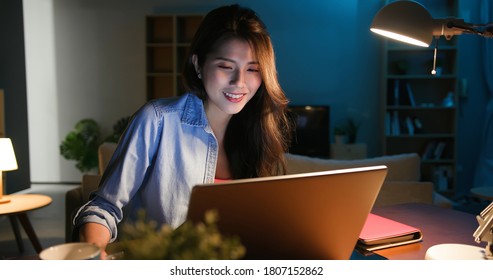 Asian Business Woman Use Computer And Work At Home In The Evening