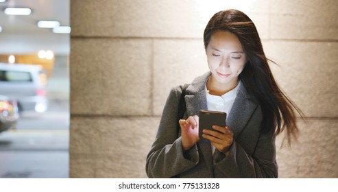 Asian Business Woman Use Of Mobile Phone At Night 