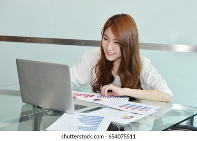 Asian Business Woman Is Using Laptop In An Office