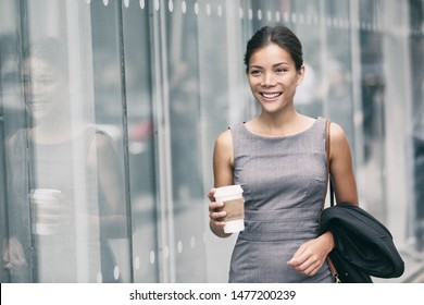 Asian Business Woman Walking Going To Work Drinking Coffee To Office Building. Successful Happy Businesswoman Commuting In The Morning In City Street.