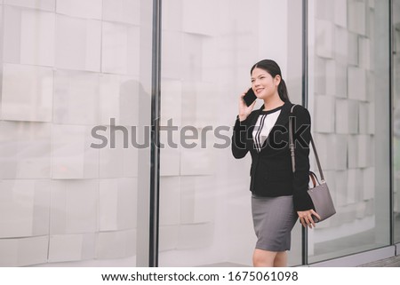 Asian business woman walking to the office while calling for business. business  concept.