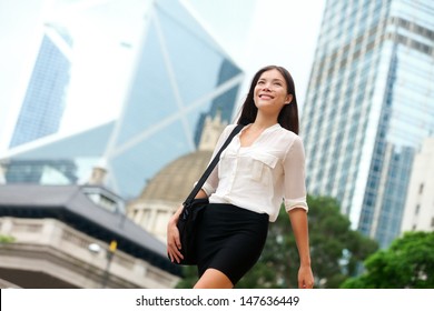 Asian Business Woman Walking Outside In Hong Kong. Asian Businesswoman Office Worker In Downtown Business District. Young Multiracial Chinese Asian / Caucasian Female Professional In Central Hong Kong