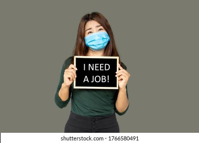 Asian Business Woman Wearing Protective Mask Hand Holding A Sign Need A Job ,Coronavirus Or COVID-19 Crisis Concept 