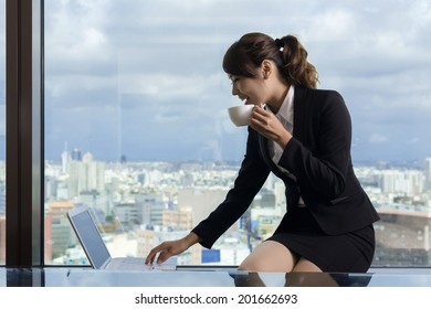 Asian Business Woman Work And Take A Cup Of Coffee In Hotel Room.