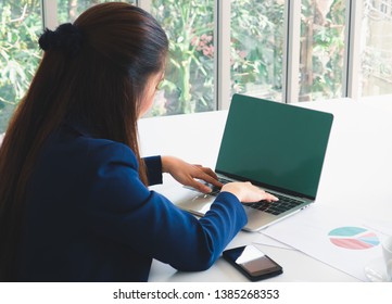 Asian business woman working by input data on laptop on the table. Green screen laptop isolate. Business concept. - Shutterstock ID 1385268353