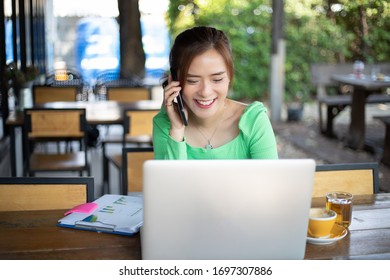 Asian Business Women Are Using Mobile And Touch Smart Phone For Communication And Women Using Notebook For Work From Home For Social Distance And Self Responsibility Concept