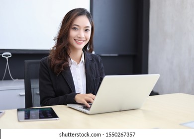 Asian business women using notebook and  smiling happy for working  - Shutterstock ID 1550267357