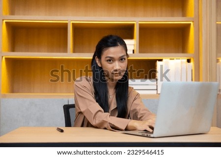 Asian business working woman work online job on laptop computer at smallbusiness home office. Work from home
