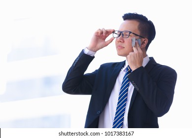 Asian business young men removing oil from face using blotting paper