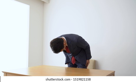 Asian Businessman Bowing For Apology