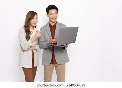 Asian Businessman And Businesswoman Looking At Laptop Computer Isolated On White Background, Feeling Happiness