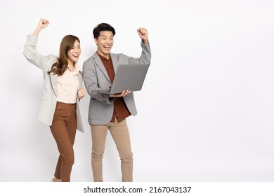 Asian Businessman And Businesswoman Looking At Laptop Computer And Hands Up Raised Arms From Happiness Isolated On White Background, Feeling Happiness And Winner Success