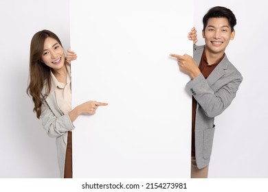 Asian businessman and businesswoman pointing and holding blank white billboard isolated on white background - Shutterstock ID 2154273981