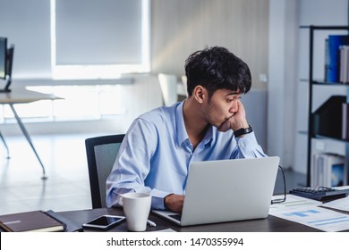 asian businessman get stress and thinking when working with laptop on desk at modern office.business fail concept.man rest hand on chin on table when stuck out of idea - Powered by Shutterstock