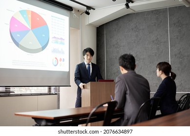 Asian Businessman Giving A Presentation At A Conference