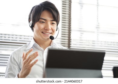 Asian Businessman Having An Online Meeting On A Computer